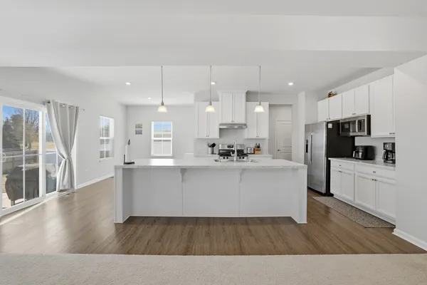 a view of kitchen with stainless steel appliances refrigerator oven and microwave