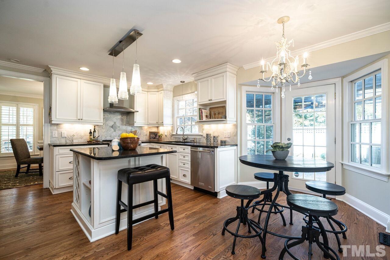 3434 Churchill Road Raleigh, NC 27607 - Photo 12 of 30 a kitchen with sink a refrigerator and chairs