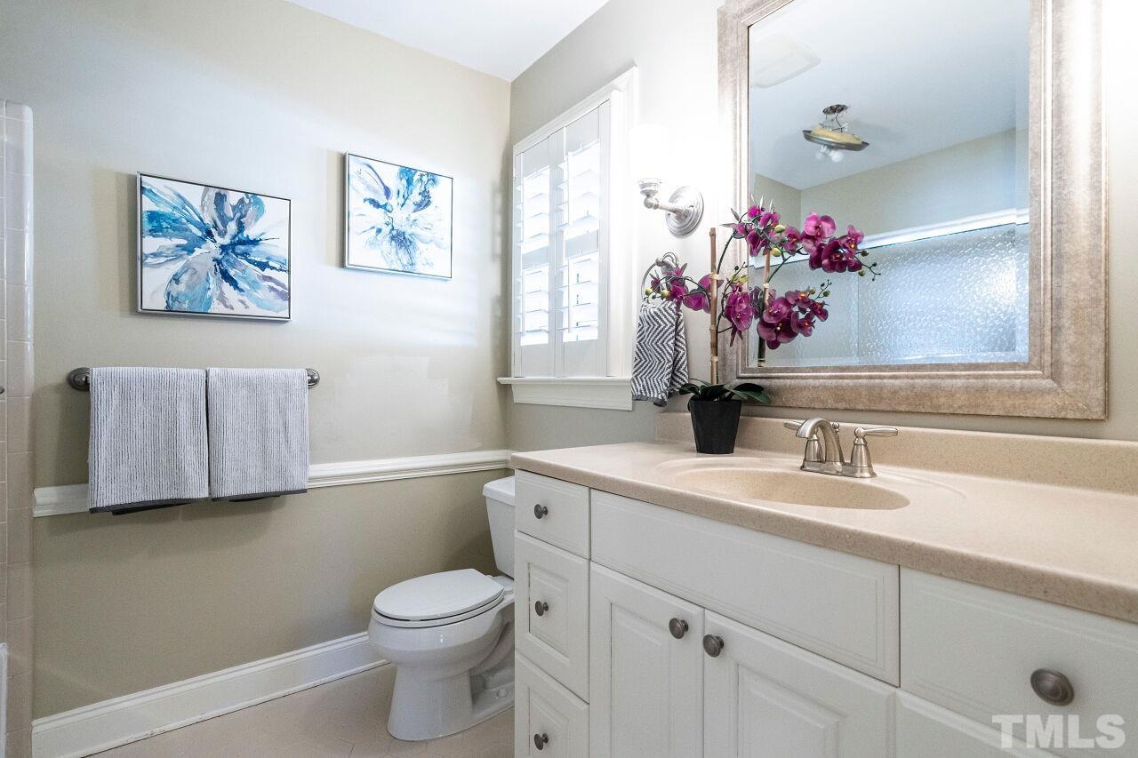 3434 Churchill Road Raleigh, NC 27607 - Photo 15 of 30 a bathroom with a sink vanity mirror and toilet