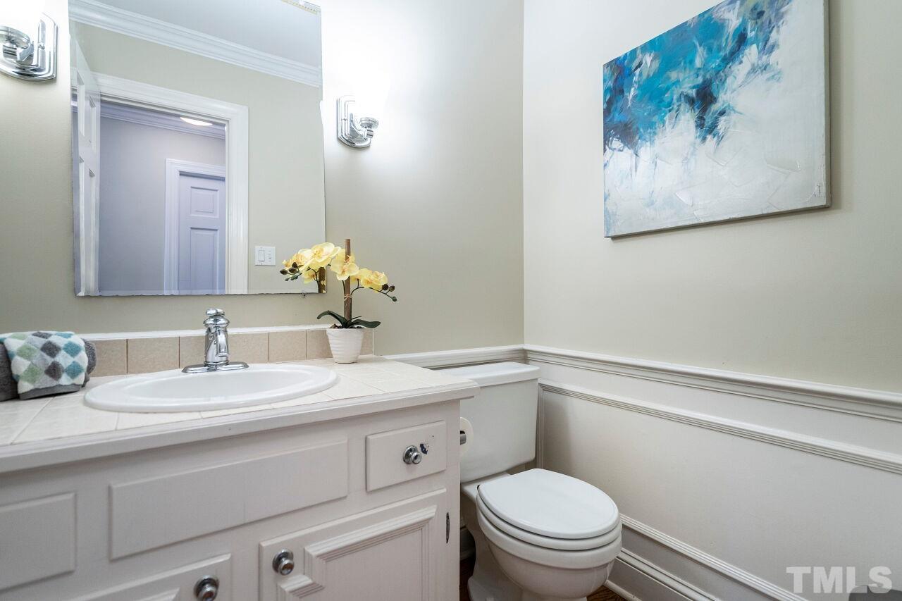 3434 Churchill Road Raleigh, NC 27607 - Photo 17 of 30 a bathroom with a toilet a sink and mirror