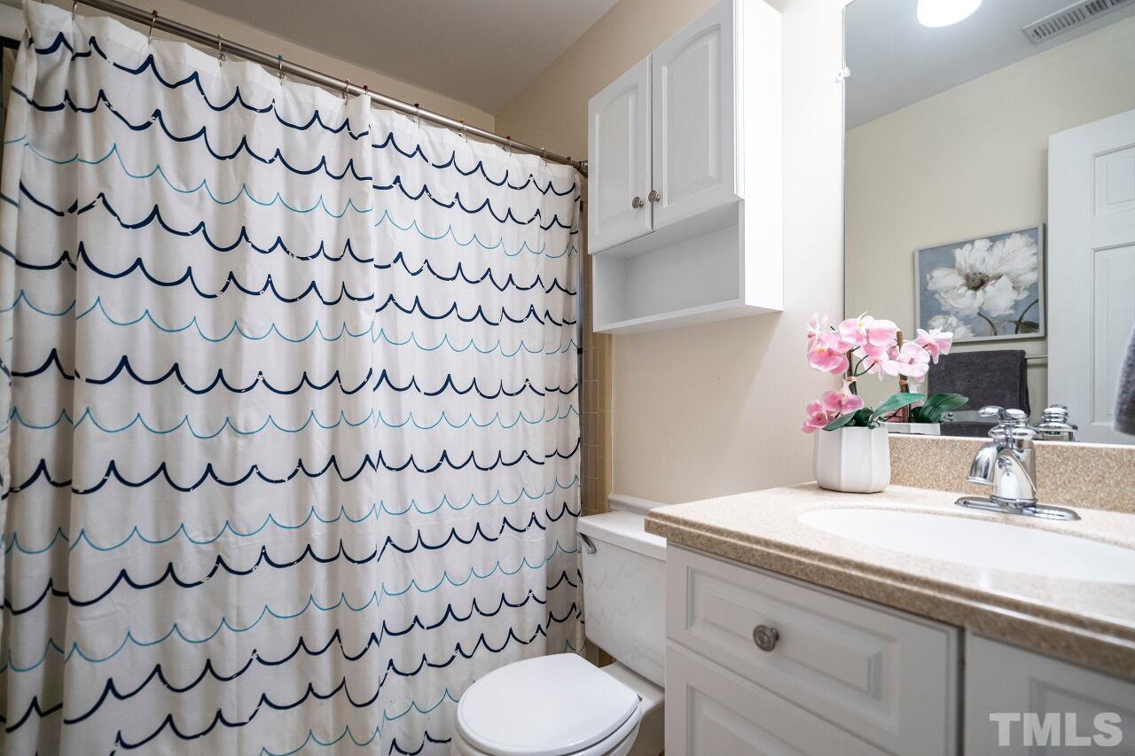 3434 Churchill Road Raleigh, NC 27607 - Photo 22 of 30 a bathroom with a sink toilet and shower