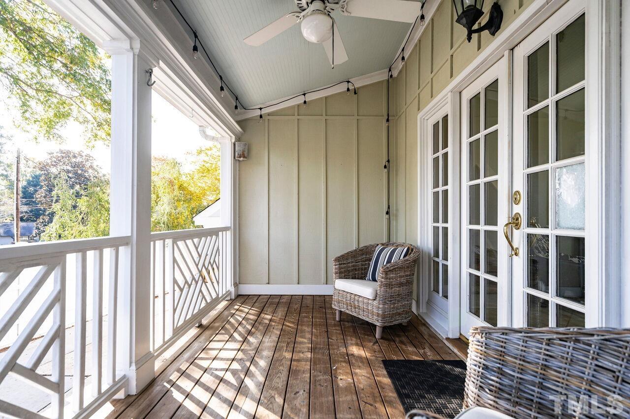 3434 Churchill Road Raleigh, NC 27607 - Photo 24 of 30 a balcony view with a couch and wooden floor