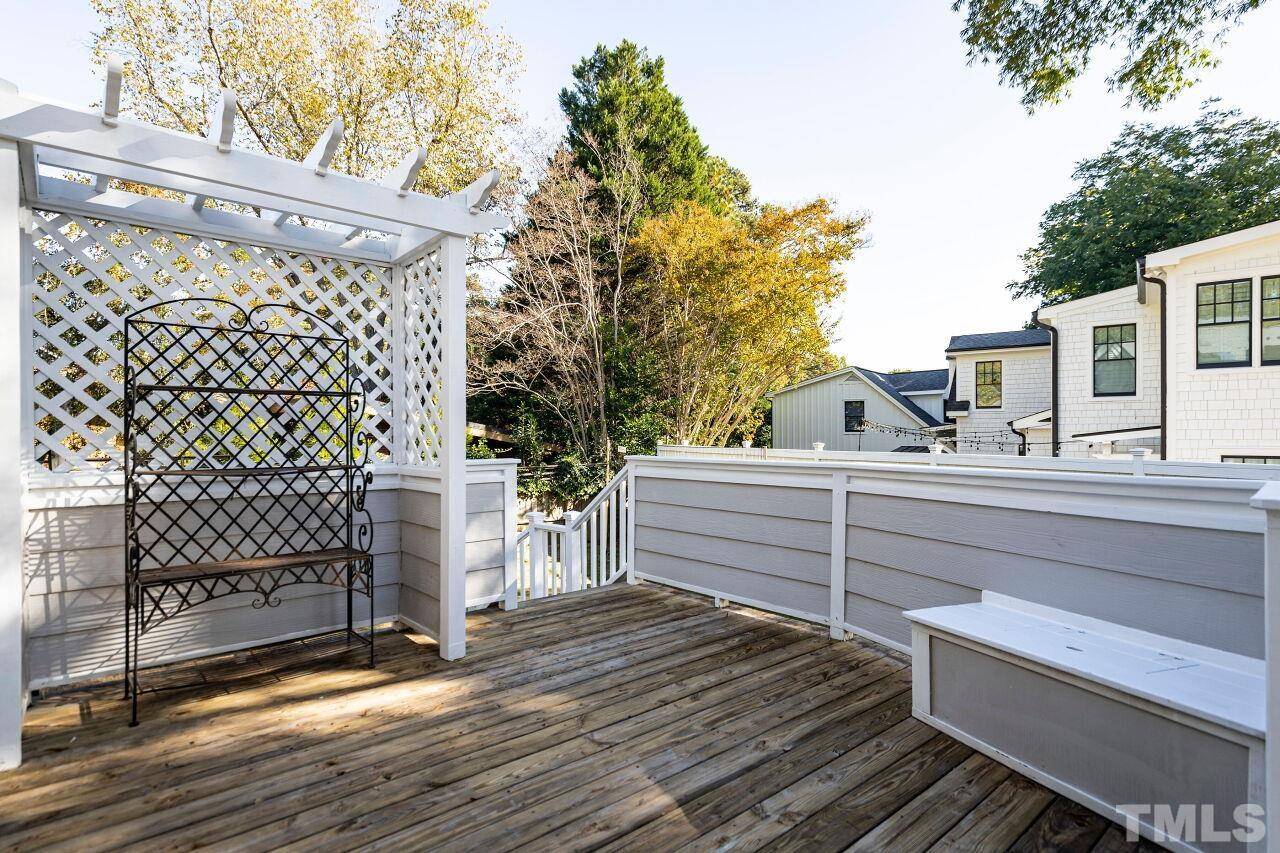 3434 Churchill Road Raleigh, NC 27607 - Photo 26 of 30 a view of a roof deck with wooden floor and fence