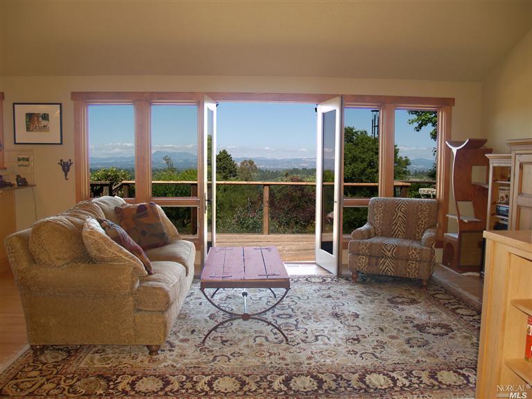 1172 Burnside Road Sebastopol, CA 95472 - Photo 1 of 1 a living room with furniture and a large window