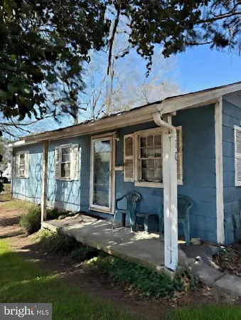 a front view of a house with a yard outdoor seating and garage