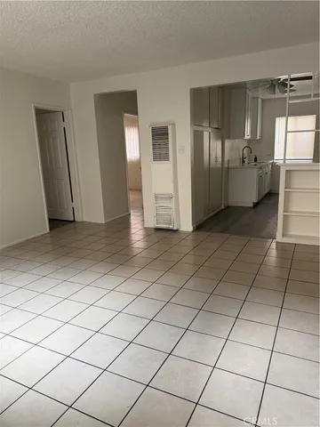 a view of a refrigerator and window in a kitchen