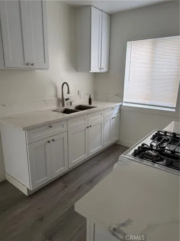 a kitchen with sink and cabinets