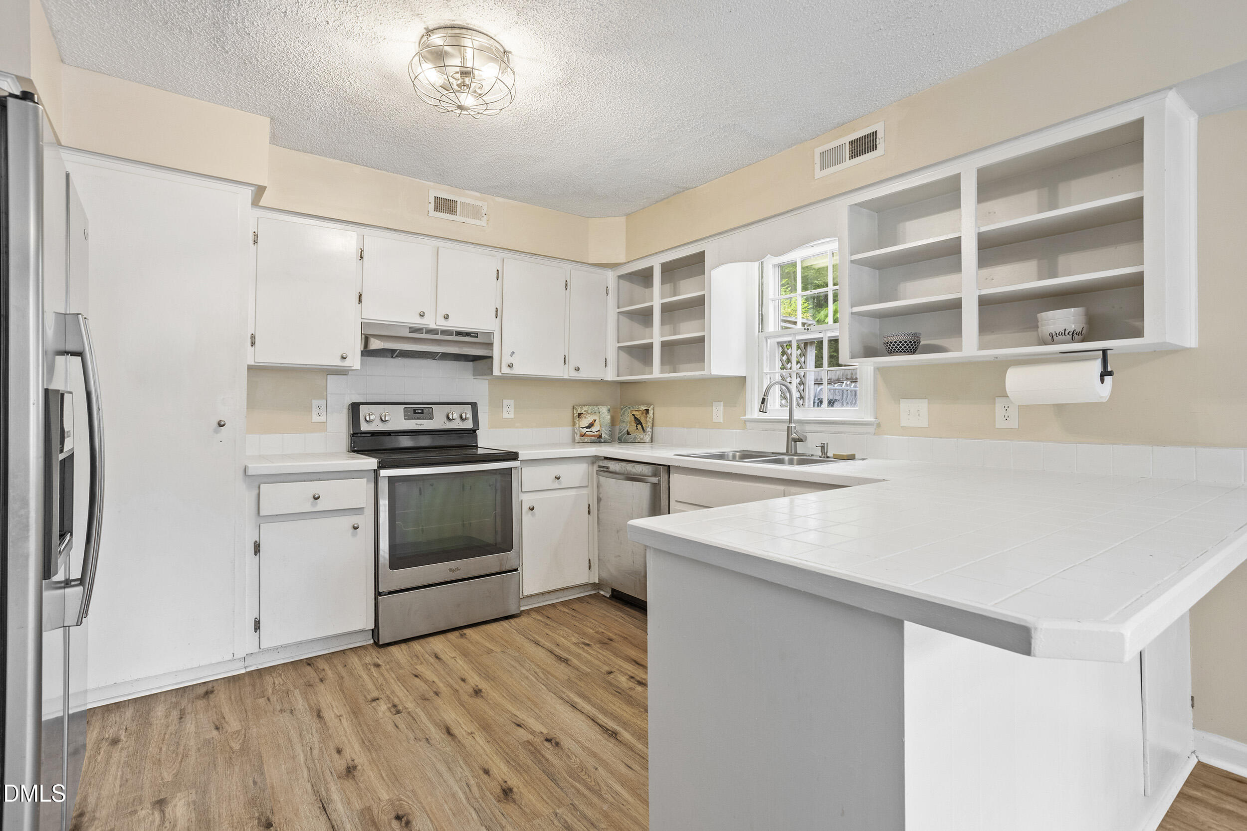 1801 Quail Ridge Road Raleigh, NC 27609 - Photo 3 of 29 a kitchen with a white cabinets and white appliances