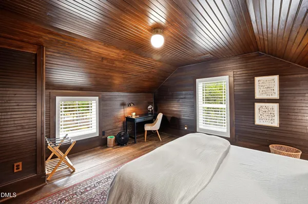 a view of a yard with plants and trees