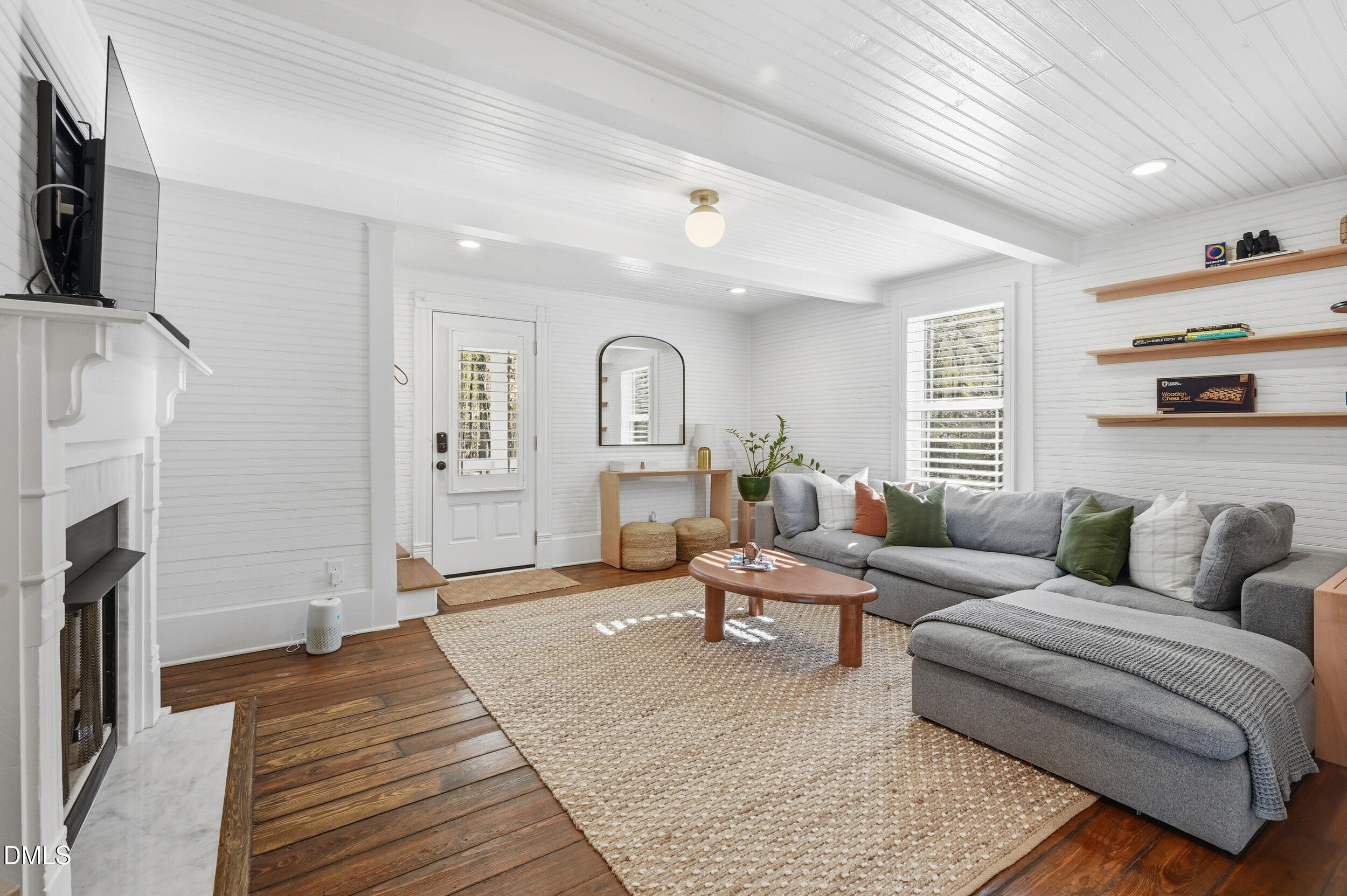 1451 Hawkins Road Hurdle Mills, NC 27541 - Photo 26 of 69 a living room with furniture a fireplace and a flat screen tv