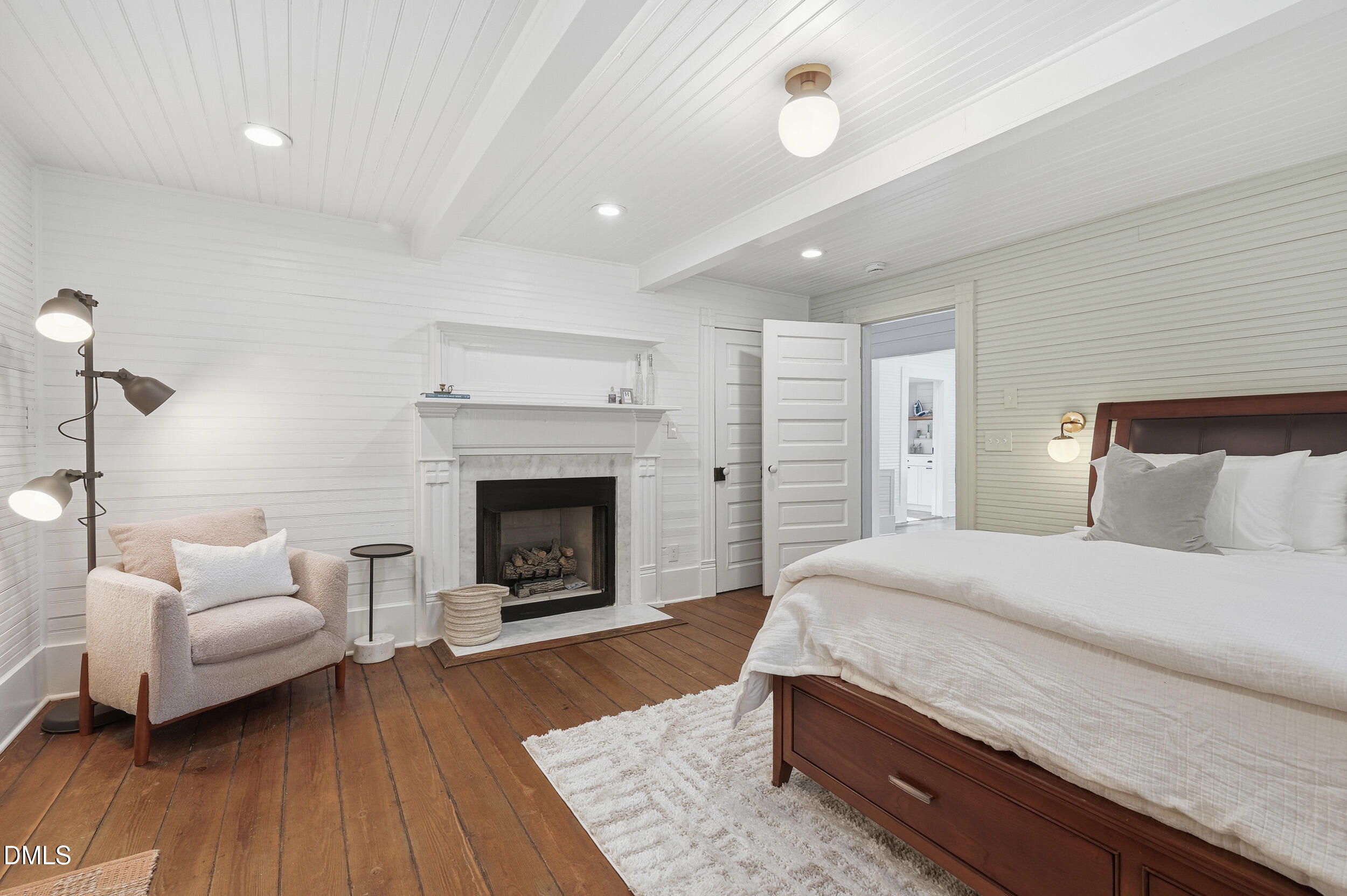 1451 Hawkins Road Hurdle Mills, NC 27541 - Photo 40 of 69 a spacious bedroom with a bed and a fireplace