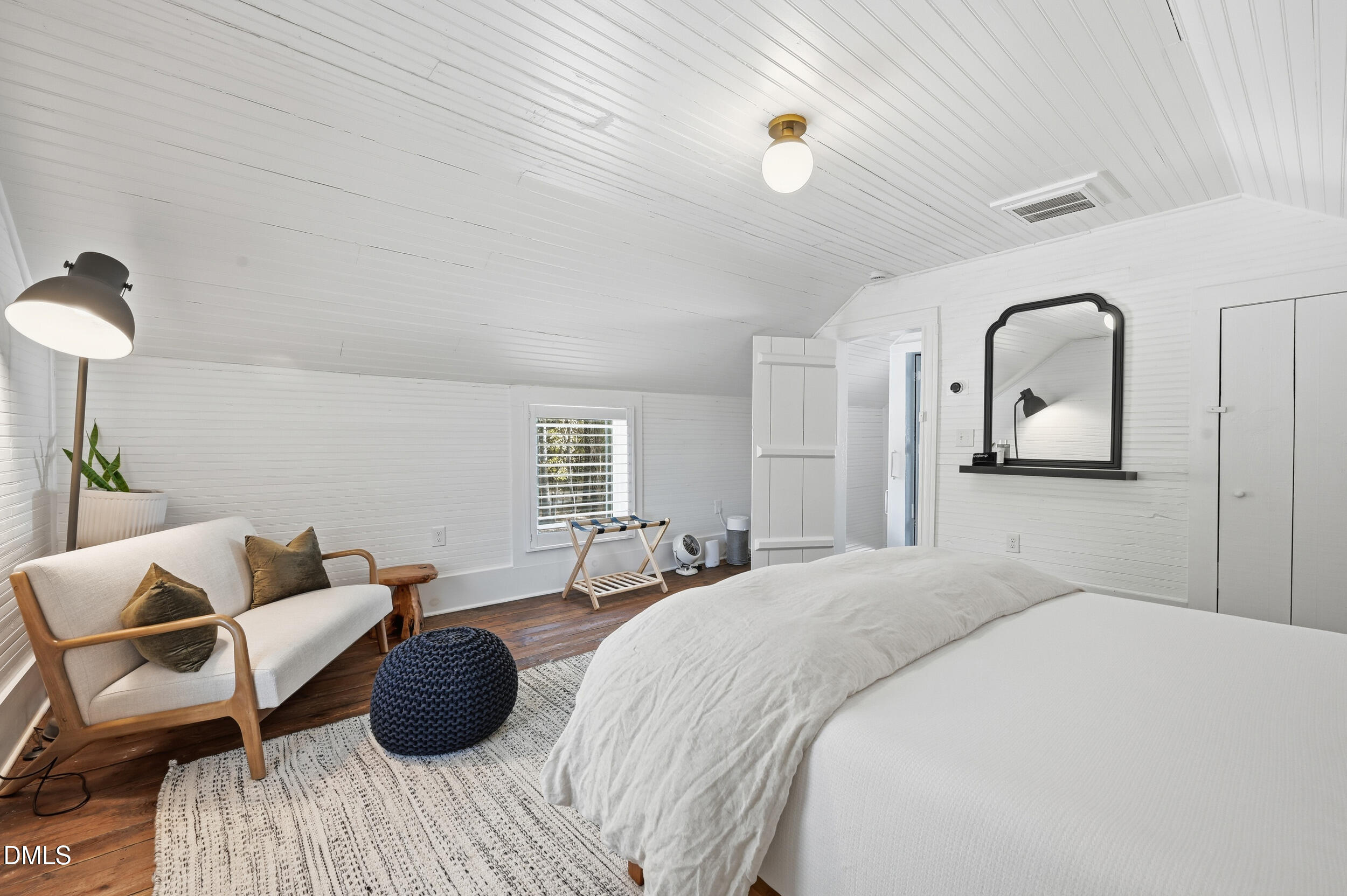 1451 Hawkins Road Hurdle Mills, NC 27541 - Photo 44 of 69 a bedroom with a bed and a chandelier