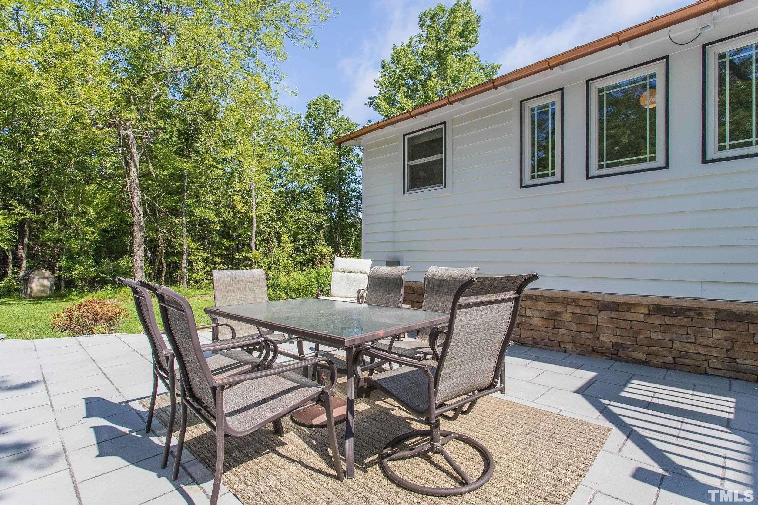 1451 Hawkins Road Hurdle Mills, NC 27541 - Photo 47 of 69 a view of a patio with table and chairs with wooden floor and fence