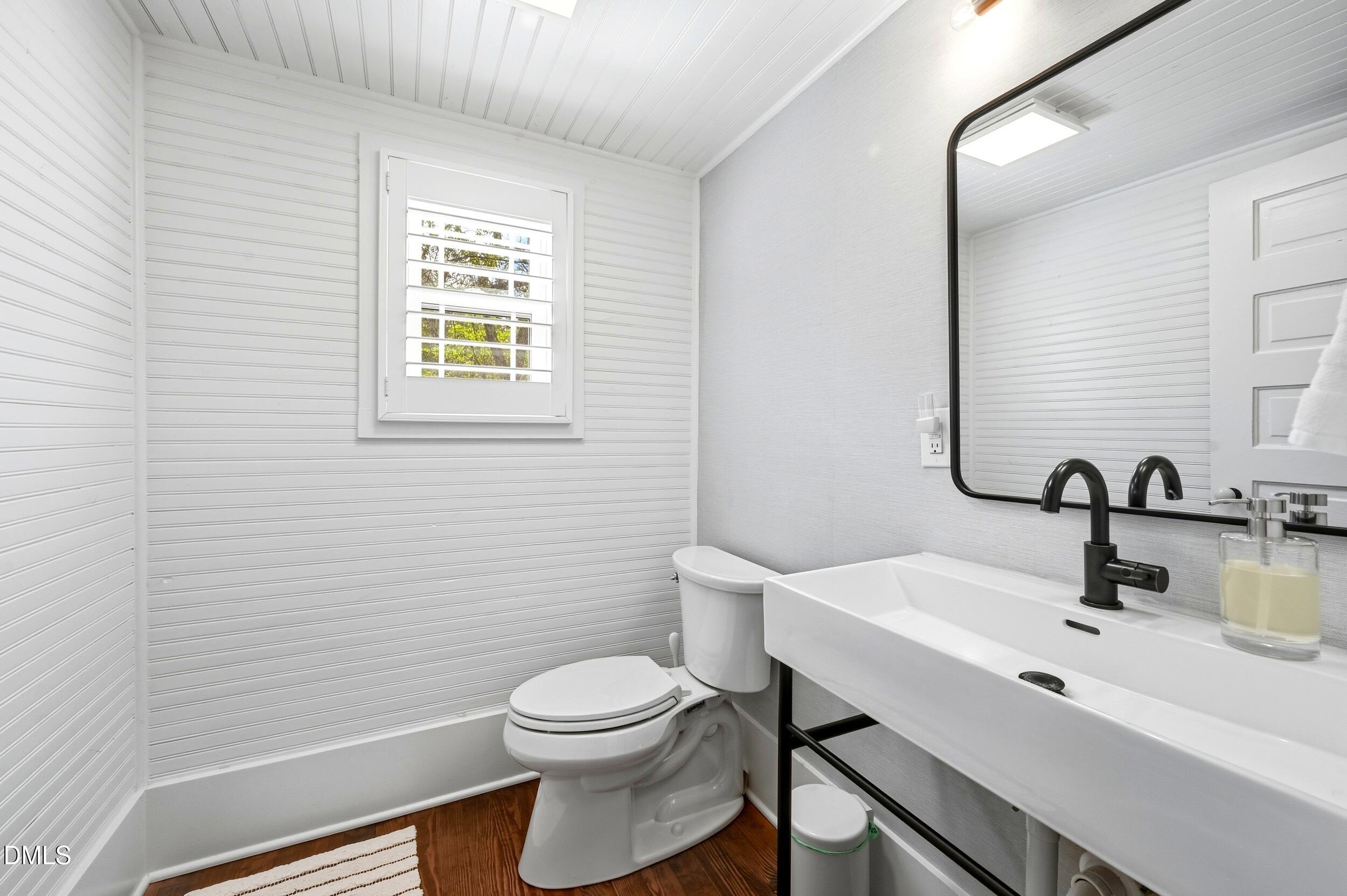 1451 Hawkins Road Hurdle Mills, NC 27541 - Photo 10 of 69 a bathroom with a toilet a sink and mirror