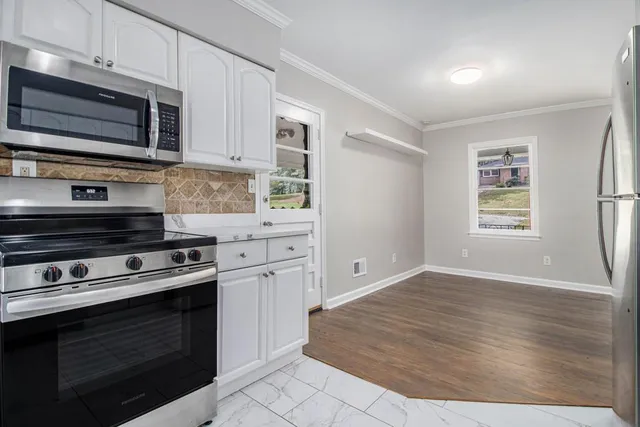 a kitchen with a stove and a microwave
