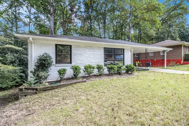 a front view of a house with garden