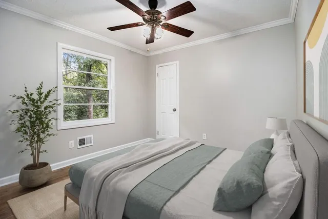 a bedroom with a bed and a window