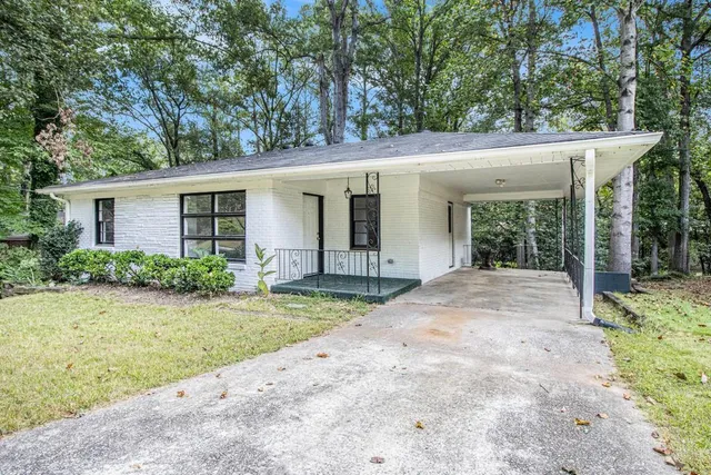 a view of a house with a yard and potted plants