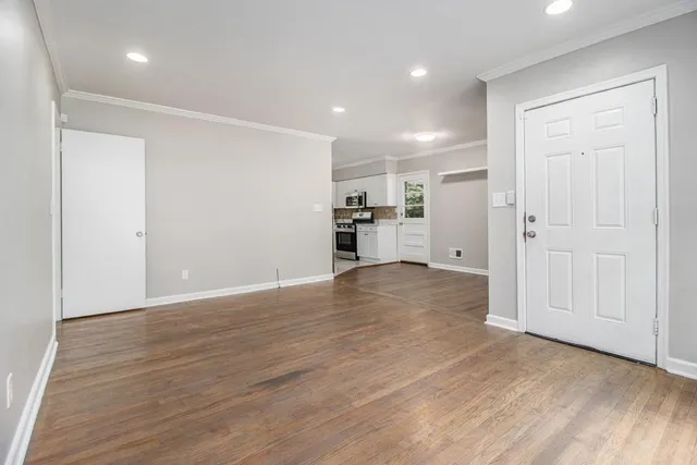 a view of a kitchen with a sink and a refrigerator