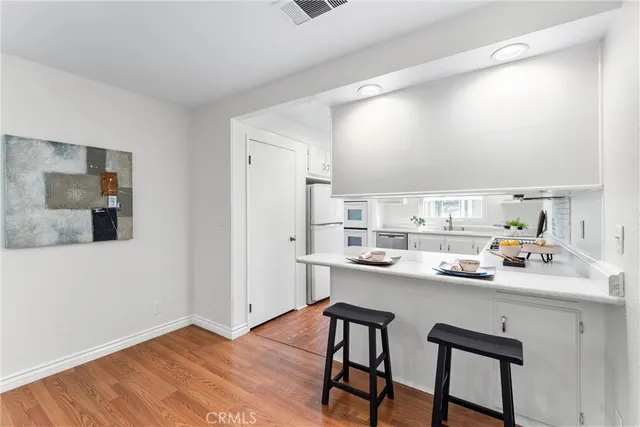 a kitchen with granite countertop a sink stainless steel appliances and cabinets