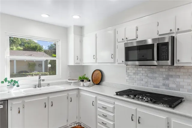 a bathroom with a granite countertop sink a toilet and a mirror