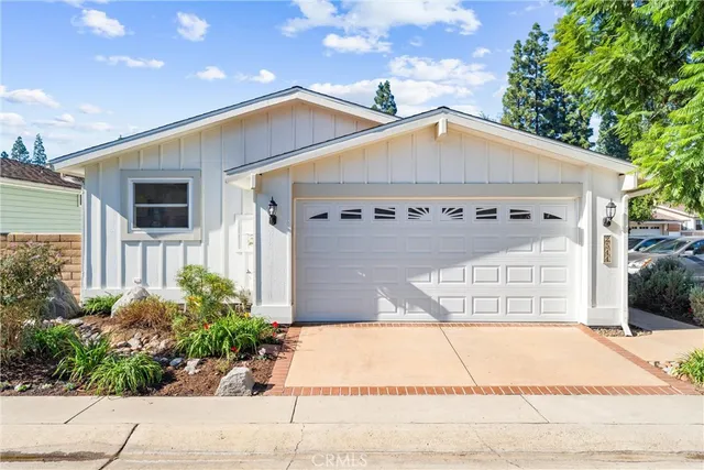 a living room with furniture and a hard wood floor