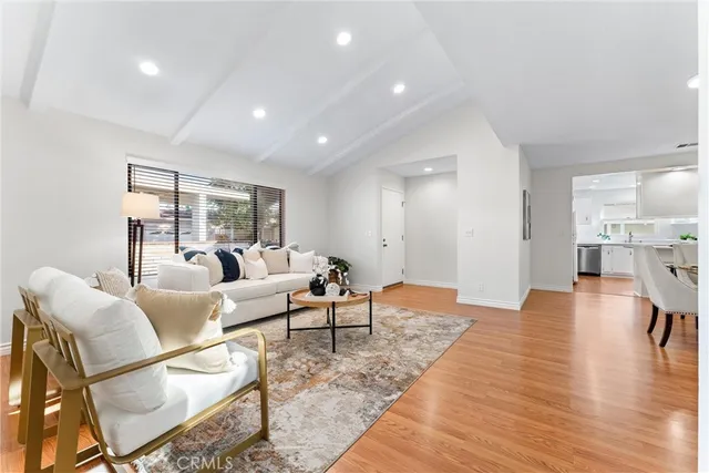 a kitchen with a sink cabinets and wooden floor