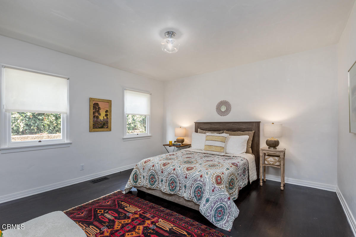 2420 Catherine Road Altadena, CA 91001 - Photo 29 of 43 a bedroom with a bed and a lamp on table