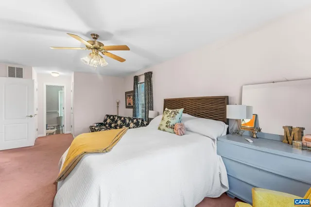 a bedroom with a bed and ceiling fan