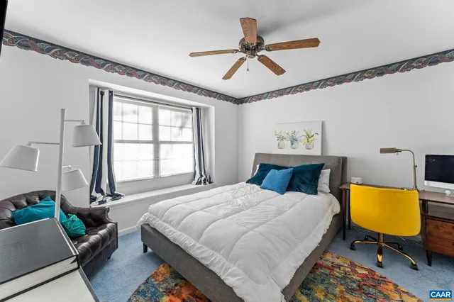 a bedroom with a bed a dresser and a window