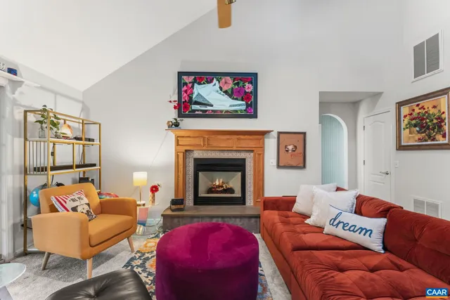 a living room with furniture and a fireplace