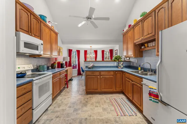 a kitchen with stainless steel appliances granite countertop a sink and cabinets