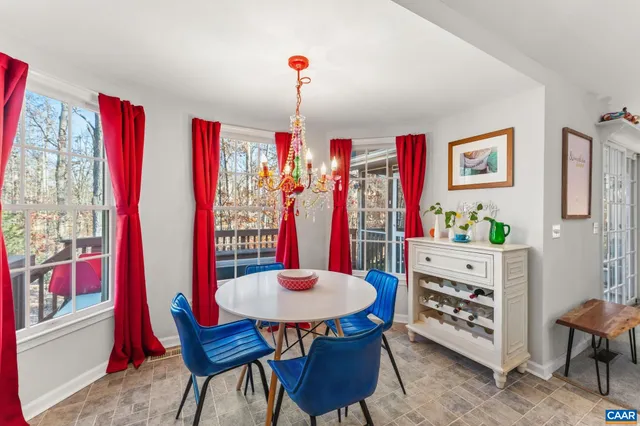 a view of a dining room with furniture and chandelier
