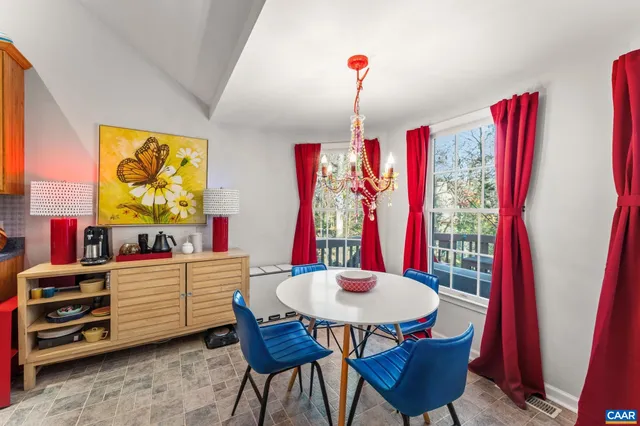 a view of a dining room with furniture and chandelier