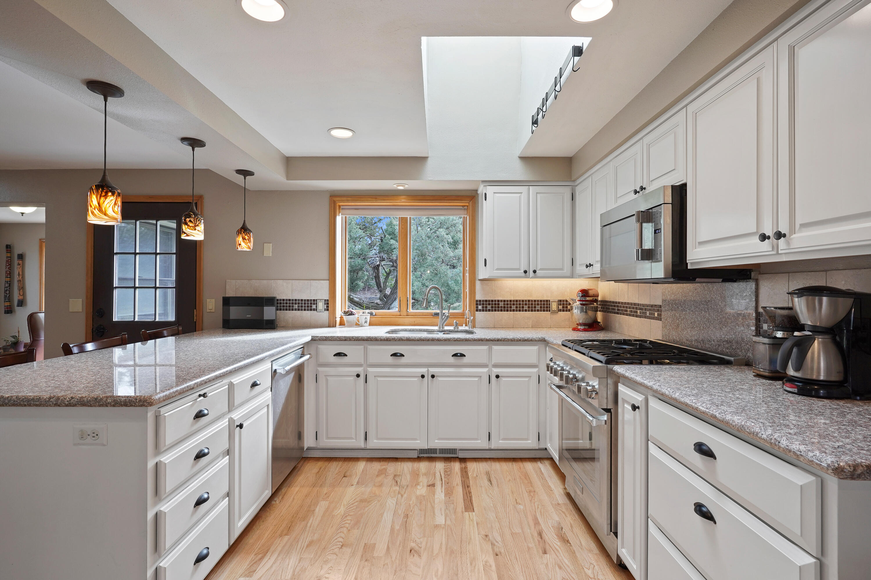70030 Meadow View Road Sisters, OR 97759 - Photo 8 of 43 a kitchen with granite countertop cabinets stainless steel appliances a sink and a window