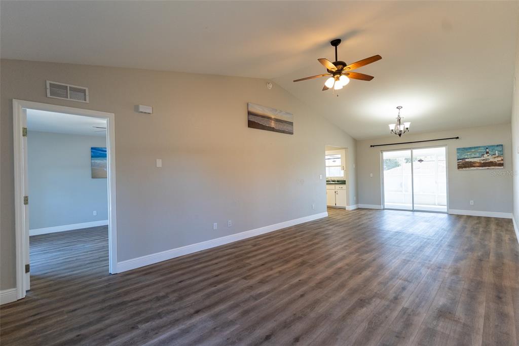 15651 Southwest 19th Terrace Ocala, FL 34473 - Photo 14 of 68 a view of an empty room with wooden floor and a window