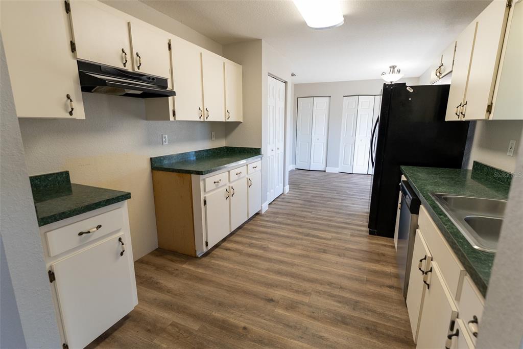 15651 Southwest 19th Terrace Ocala, FL 34473 - Photo 17 of 68 a kitchen with granite countertop a refrigerator stove and sink