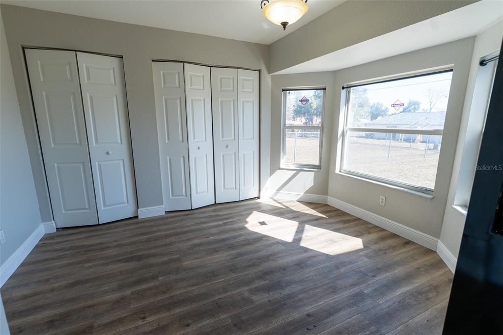 15651 Southwest 19th Terrace Ocala, FL 34473 - Photo 20 of 68 a view of empty room with wooden floor and fan