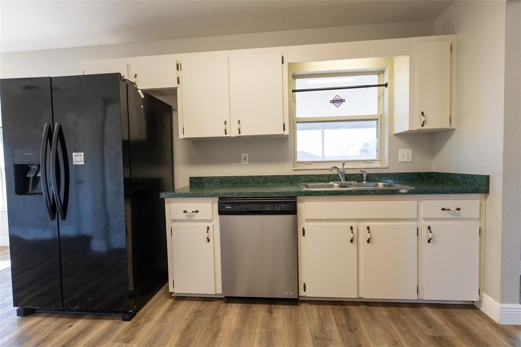 15651 Southwest 19th Terrace Ocala, FL 34473 - Photo 23 of 68 a kitchen with stainless steel appliances granite countertop a refrigerator and a stove