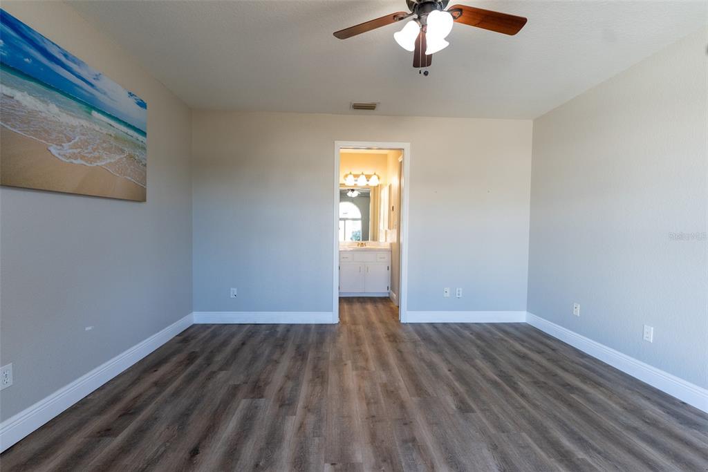 15651 Southwest 19th Terrace Ocala, FL 34473 - Photo 26 of 68 a view of empty room with wooden floor and fan