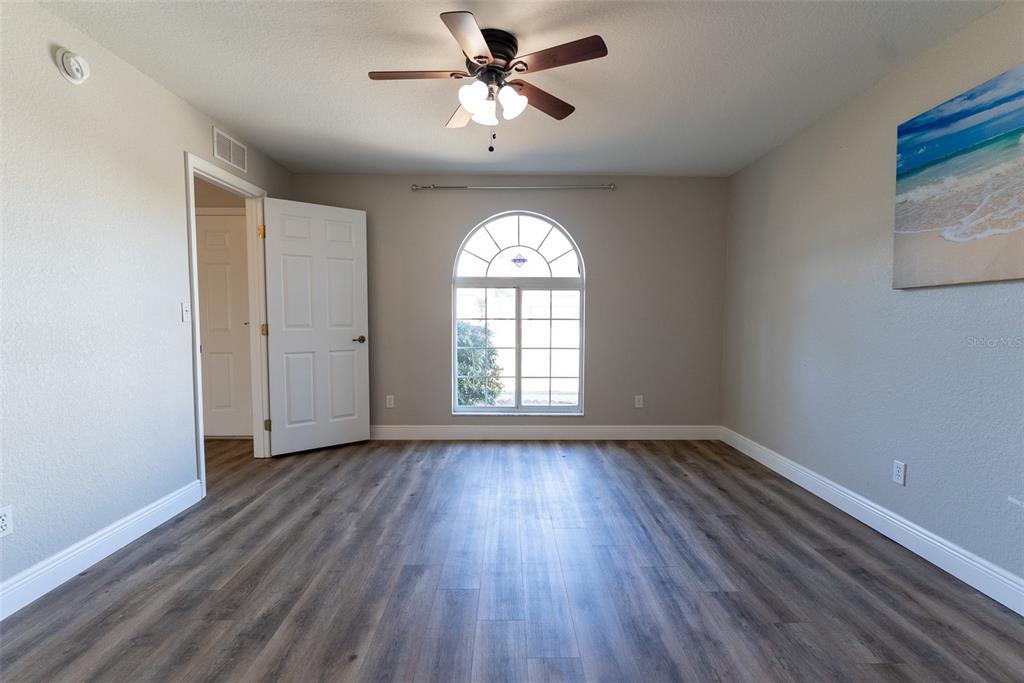 15651 Southwest 19th Terrace Ocala, FL 34473 - Photo 30 of 68 a view of empty room with wooden floor and fan