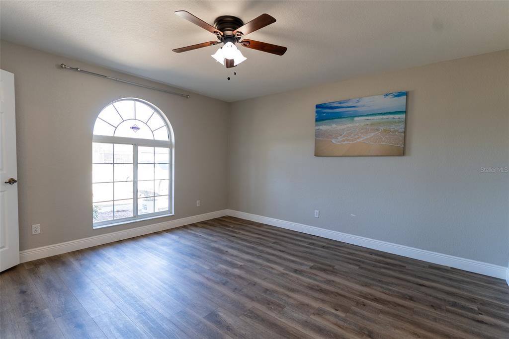 15651 Southwest 19th Terrace Ocala, FL 34473 - Photo 31 of 68 a view of an empty room with wooden floor and a window