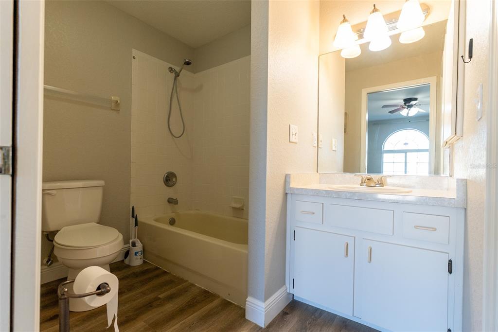 15651 Southwest 19th Terrace Ocala, FL 34473 - Photo 32 of 68 a bathroom with a granite countertop toilet a sink and a mirror