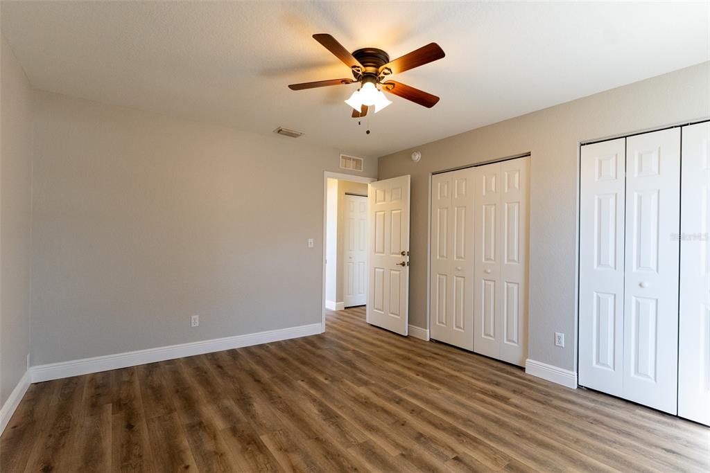 15651 Southwest 19th Terrace Ocala, FL 34473 - Photo 41 of 68 an empty room with wooden floor and ceiling fan