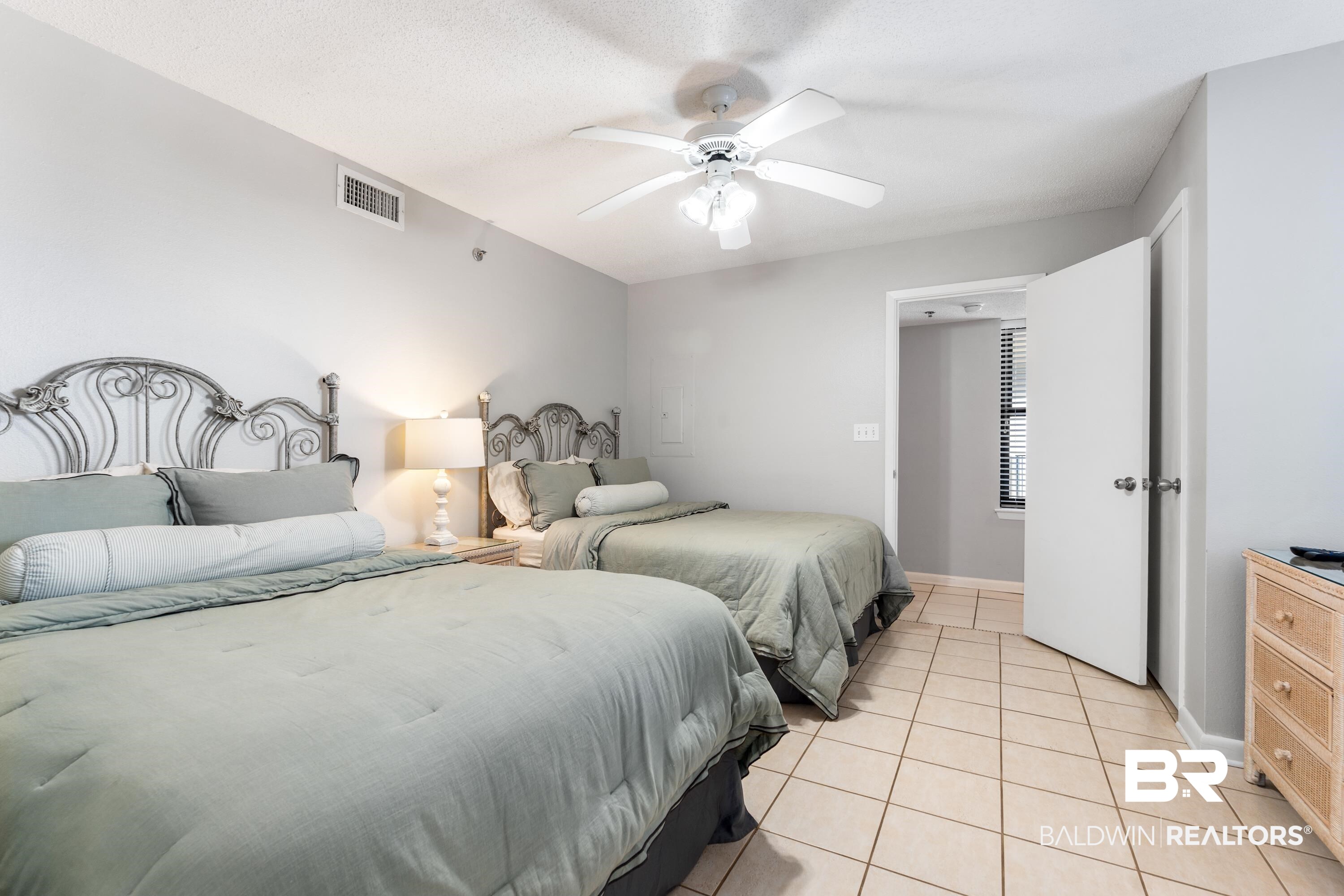 26802 Perdido Beach Boulevard, Unit 406 Orange Beach, AL 36561 - Photo 16 of 37 Bedroom featuring light tile patterned floors and a ceiling fan