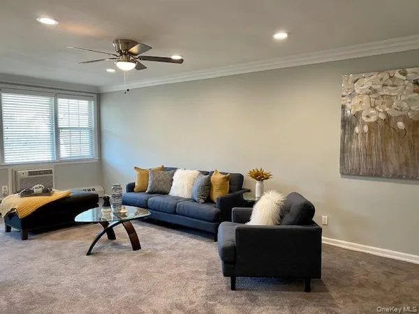 a living room with furniture and a large window
