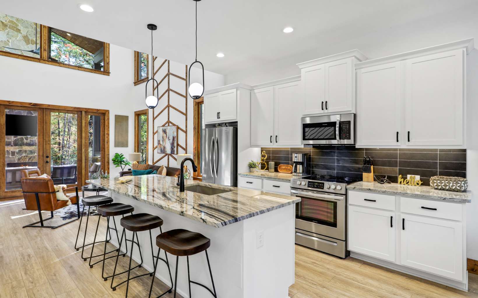 a kitchen with stainless steel appliances kitchen island granite countertop a stove a sink dishwasher a dining table and chairs with wooden floor