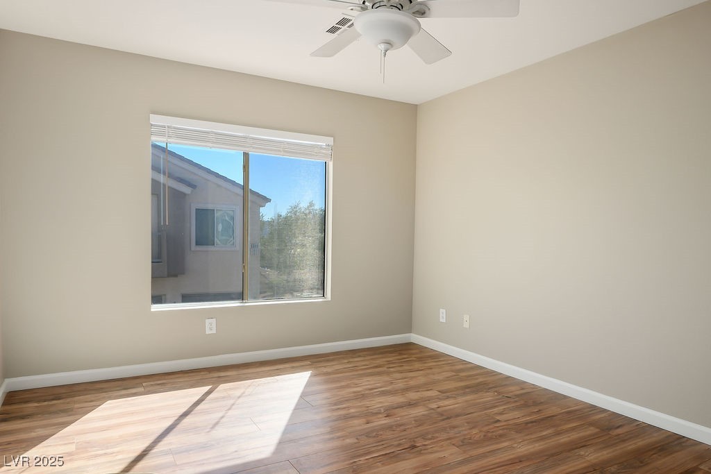 6610 Tumbleweed Ridge Lane, Unit 101 Henderson, NV 89011 - Photo 16 of 24 Spare room featuring wood finished floors and a ceiling fan
