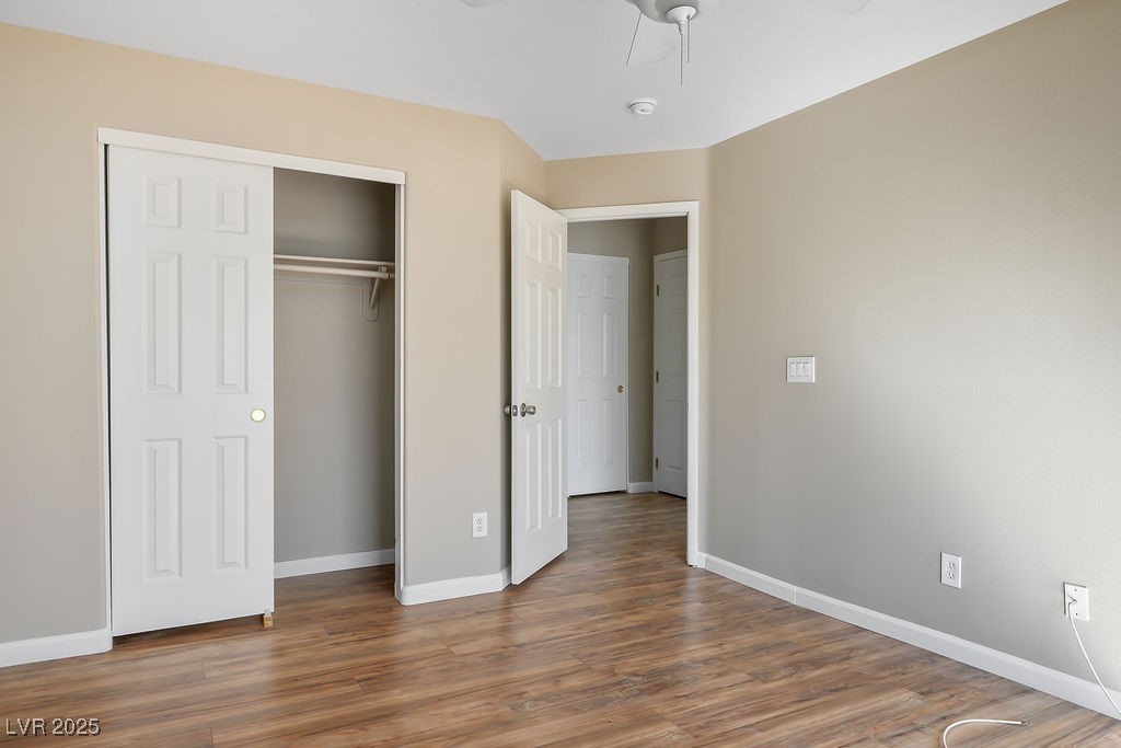 6610 Tumbleweed Ridge Lane, Unit 101 Henderson, NV 89011 - Photo 17 of 24 Unfurnished bedroom featuring wood finished floors, a closet, and a ceiling fan