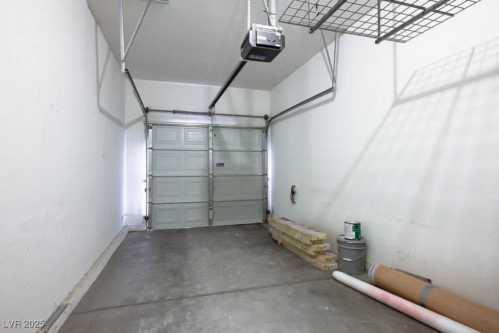 6610 Tumbleweed Ridge Lane, Unit 101 Henderson, NV 89011 - Photo 22 of 24 Garage featuring a garage door opener